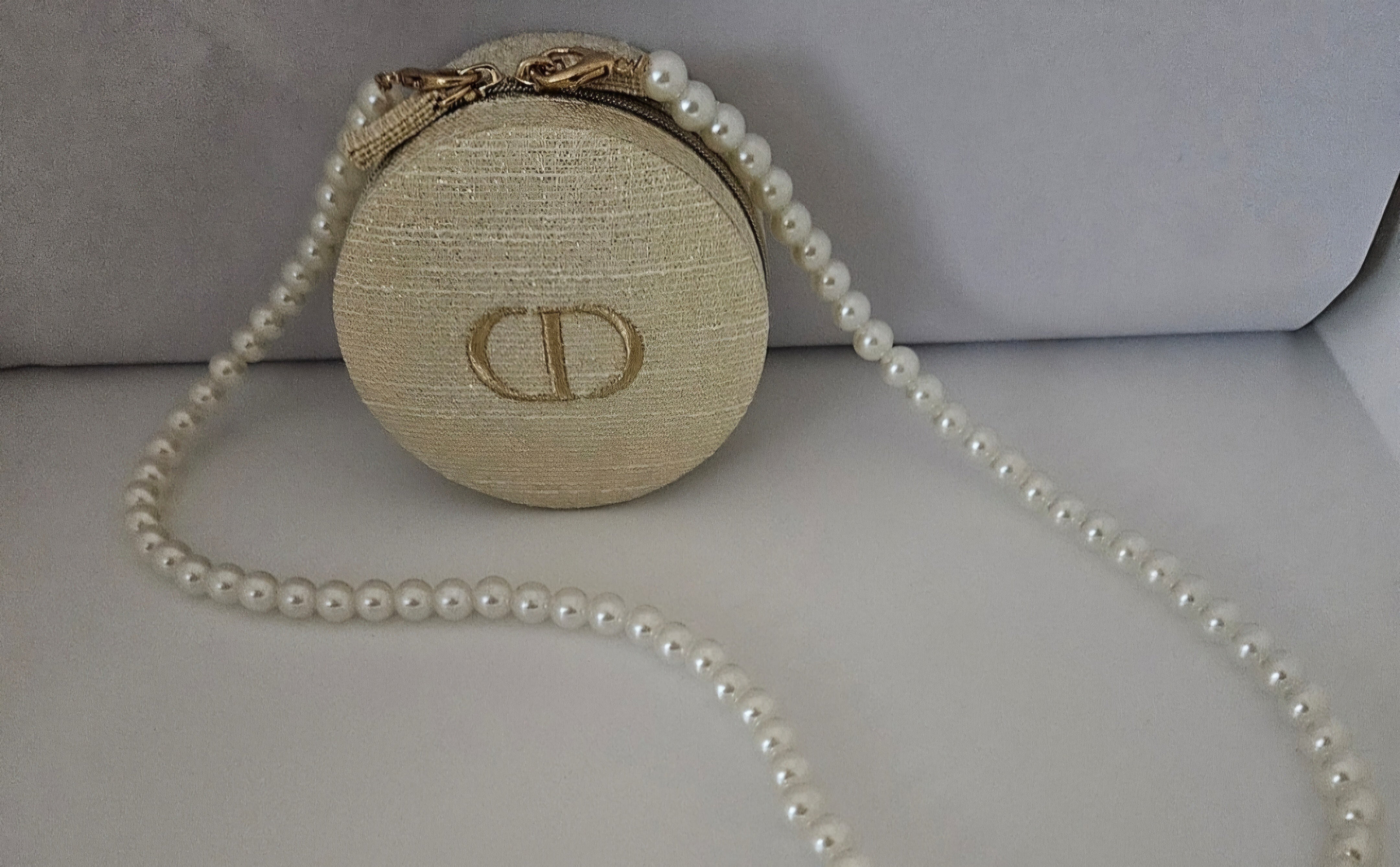 Dior Round Zippered Pouch with pearl crossbody strap