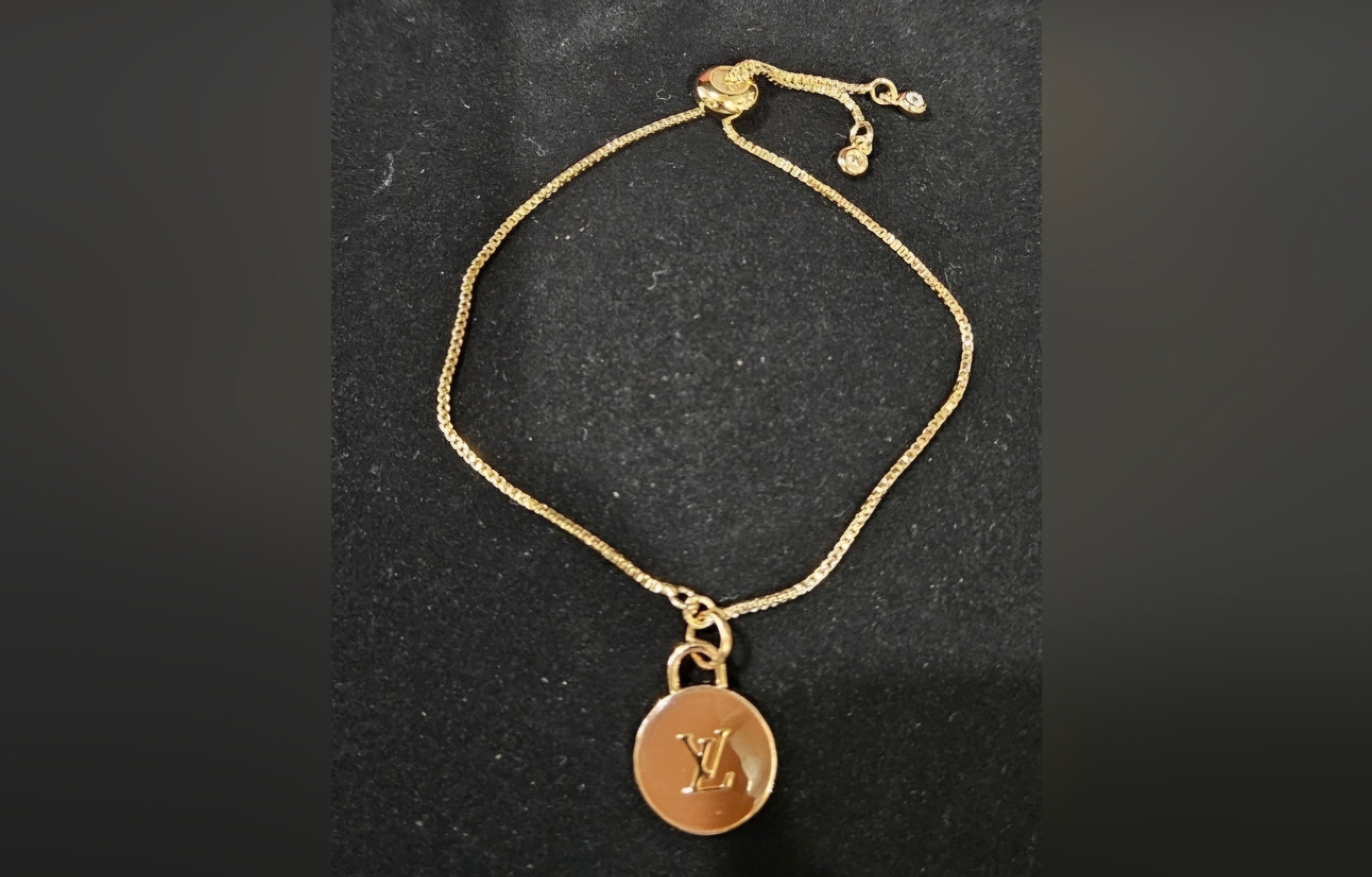 Louis Vuitton charm on gold bracelet